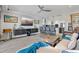 Open-concept living area with sleek gray tile floors, stylish furniture, and an island with bar stool seating at 380 Pinellas Bayway S. # E, Tierra Verde, FL 33715