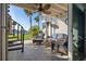 Outdoor patio with wicker furniture, ceiling fan, and spiral staircase to the backyard at 380 Pinellas Bayway S. # E, Tierra Verde, FL 33715
