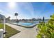 Community pool with waterfront views, lounge chairs, and landscaping at 380 Pinellas Bayway S. # E, Tierra Verde, FL 33715