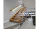 Open staircase with wood treads, metal railing, and views into the living area of the home at 380 Pinellas Bayway S. # E, Tierra Verde, FL 33715