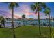 Scenic waterfront view featuring lush landscaping, docks, and luxury homes under a vibrant sunset sky at 380 Pinellas Bayway S. # E, Tierra Verde, FL 33715