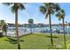 Scenic waterfront view featuring lush landscaping, docks, and luxury homes under a clear blue sky at 380 Pinellas Bayway S. # E, Tierra Verde, FL 33715