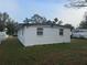 House rear view, showing yard and satellite dish at 4106 W Mango Ave, Tampa, FL 33616