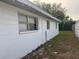 White side exterior wall with small yard at 4106 W Mango Ave, Tampa, FL 33616