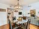 Bright dining room with a glass-top table, four chairs, and a modern chandelier at 4209 E 98Th Ave, Tampa, FL 33617