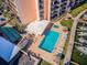 Aerial view of condo building with boat slips, pool, jacuzzi, shuffleboard, and tiki huts at 51 Island Way # 1004, Clearwater Beach, FL 33767