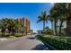 Exterior view of the building showcasing lush tropical landscaping and a well-maintained entrance area at 51 Island Way # 1004, Clearwater Beach, FL 33767