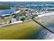 Picturesque aerial shot featuring a tennis court, pier, and beachfront access at 611 Destiny Dr # 410, Ruskin, FL 33570