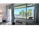 Stunning balcony view of the ocean and palm trees framed by stylish curtains at 611 Destiny Dr # 410, Ruskin, FL 33570