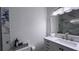 Bright bathroom features white vanity with marble backsplash and modern fixtures at 611 Destiny Dr # 410, Ruskin, FL 33570