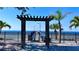 A lovely beach access point with a gate leading to a stunning view of the ocean on a sunny day at 611 Destiny Dr # 410, Ruskin, FL 33570