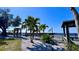 A pair of beach gazebos along the community's beach and waterfront area, along with tropical palm trees at 611 Destiny Dr # 410, Ruskin, FL 33570