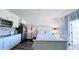 A modern bedroom with a stainless refrigerator, kitchenette, and views of the balcony at 611 Destiny Dr # 410, Ruskin, FL 33570