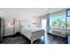 Comfortable bedroom with a queen bed, stylish lighting, and views of palm trees at 611 Destiny Dr # 410, Ruskin, FL 33570