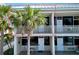 Charming condo exterior featuring white railings and a lush palm tree at 611 Destiny Dr # 410, Ruskin, FL 33570