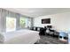 This living room features a queen bed, workspace, and views of palm trees and a balcony at 611 Destiny Dr # 410, Ruskin, FL 33570