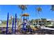 A colorful playground with a slide, climbing structure, and swings for to have some fun in the sun at 611 Destiny Dr # 410, Ruskin, FL 33570