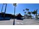 Sunset Bar & Grill entrance framed by tall palm trees with ample parking at 611 Destiny Dr # 410, Ruskin, FL 33570