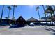 A tropical Sunset Bar & Grill with a tiki roof and palm trees, creating a vacation-like experience at 611 Destiny Dr # 410, Ruskin, FL 33570