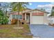 Brick ranch home with attached garage and landscaped yard at 651 Southwest N Blvd, St Petersburg, FL 33703