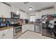 Kitchen with stainless steel appliances and white cabinets at 651 Southwest N Blvd, St Petersburg, FL 33703