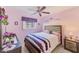 Bedroom with a queen bed and purple color scheme at 6901 59Th N Way, Pinellas Park, FL 33781