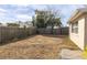Large backyard with wooden fence and grassy area at 7014 Ivanhoe Dr, Port Richey, FL 34668