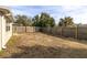 Large backyard area with a wooden fence at 7014 Ivanhoe Dr, Port Richey, FL 34668