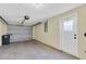 Bright garage interior with an overhead door and extra storage at 7014 Ivanhoe Dr, Port Richey, FL 34668