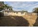 Tan house exterior with a large backyard at 7014 Ivanhoe Dr, Port Richey, FL 34668