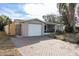 House exterior with a brick driveway and screened porch at 7014 Ivanhoe Dr, Port Richey, FL 34668