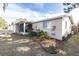House exterior with landscaping and a brick driveway at 7014 Ivanhoe Dr, Port Richey, FL 34668