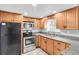 Updated kitchen with light wood cabinets and stainless steel appliances at 7014 Ivanhoe Dr, Port Richey, FL 34668