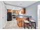Modern kitchen with wood cabinets, granite countertops, and stainless steel appliances at 7014 Ivanhoe Dr, Port Richey, FL 34668
