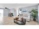 Living room with light gray walls, a comfy couch, and a wood coffee table at 7014 Ivanhoe Dr, Port Richey, FL 34668