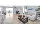 Open living room and dining area with neutral decor and tile floors at 7014 Ivanhoe Dr, Port Richey, FL 34668