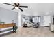 Bright living room with tile floors, comfy couch, and a ceiling fan at 7014 Ivanhoe Dr, Port Richey, FL 34668