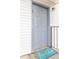 Gray front door with teal welcome mat at 7124 Waterside Dr # 7124, Tampa, FL 33617