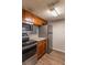 Modern kitchen with stainless steel appliances and wood cabinets at 7124 Waterside Dr # 7124, Tampa, FL 33617