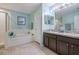 Elegant bathroom with double vanity and garden tub at 7440 Dragon Fly Loop, Gibsonton, FL 33534