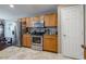 Kitchen with stainless steel appliances and light oak cabinets at 7440 Dragon Fly Loop, Gibsonton, FL 33534