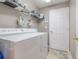 Convenient laundry room with washer, dryer, and overhead shelving at 7440 Dragon Fly Loop, Gibsonton, FL 33534