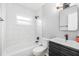 Clean bathroom with tub and shower, white subway tile, and a modern vanity at 775 90Th N Ave, St Petersburg, FL 33702