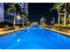 Luxury rooftop pool at night with city lights at 777 N Ashley Dr # 2503, Tampa, FL 33602