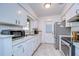 Galley-style kitchen with white cabinets and stainless steel appliances at 8504 Woodall Ct, Tampa, FL 33615