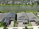 Aerial view of house and neighborhood, showcasing location by the lake at 9608 Ivory Dr, Ruskin, FL 33573