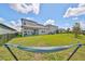 Spacious backyard with a hammock and a view of the neighborhood at 9608 Ivory Dr, Ruskin, FL 33573