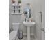 Small bathroom with pedestal sink and oval mirror at 9608 Ivory Dr, Ruskin, FL 33573