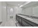 Modern bathroom with dual sinks, granite countertop, and a tub at 9608 Ivory Dr, Ruskin, FL 33573