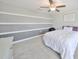 Upstairs bedroom with a queen bed and unique wall design at 9608 Ivory Dr, Ruskin, FL 33573